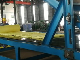 Blanket rolling and packing machine